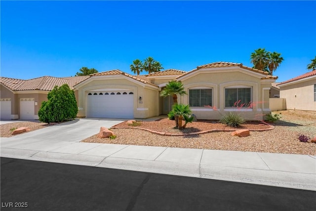 8541 Highland View Ave, Las Vegas, NV 89145 - mediterranean / spanish-style house with an attached garage, stucco siding, concrete driveway, and a tiled roof