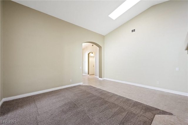 8541 Highland View Ave, Las Vegas, NV 89145 - unfurnished room with high vaulted ceiling, arched walkways, baseboards, and tile patterned floors
