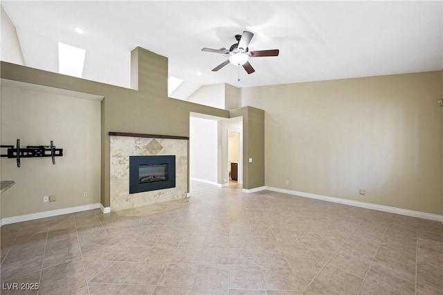 8541 Highland View Ave, Las Vegas, NV 89145 - unfurnished living room featuring a ceiling fan, a premium fireplace, baseboards, and lofted ceiling