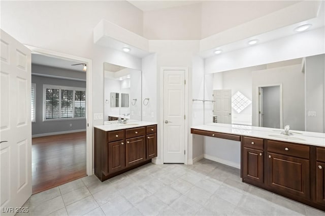 8541 Highland View Ave, Las Vegas, NV 89145 - bathroom featuring baseboards and two vanities