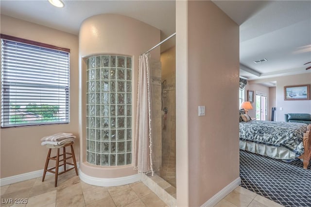 2982 Hammerwood Dr, Las Vegas, NV 89135 - bathroom featuring connected bathroom, a tile shower, baseboards, and tile patterned floors