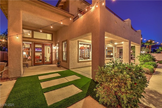 2982 Hammerwood Dr, Las Vegas, NV 89135 - exterior entry at night featuring stucco siding and french doors