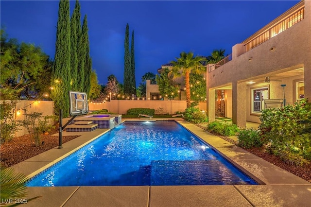 2982 Hammerwood Dr, Las Vegas, NV 89135 - pool at twilight with a fenced backyard and an in-ground hot tub