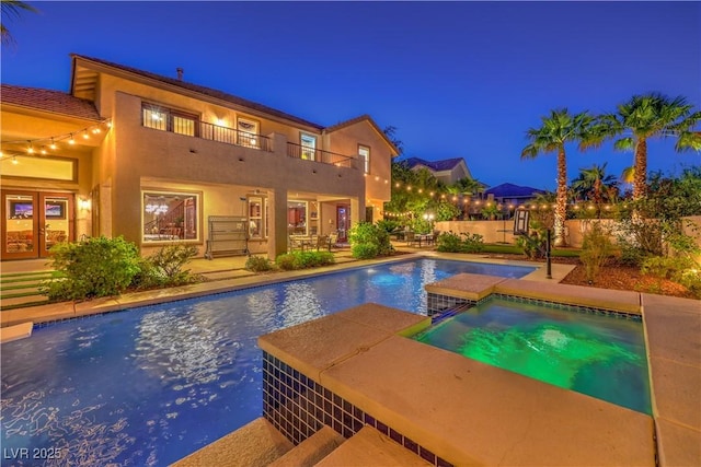 2982 Hammerwood Dr, Las Vegas, NV 89135 - pool at twilight with french doors, an outdoor pool, and a patio