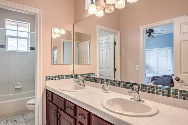 2982 Hammerwood Dr, Las Vegas, NV 89135 - full bath with double vanity, toilet, a chandelier,  shower combination, and tasteful backsplash