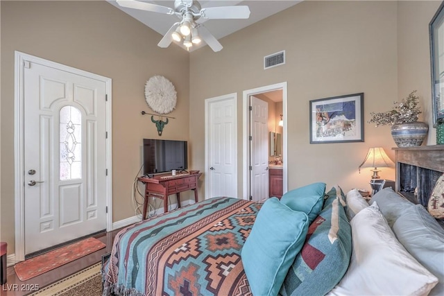 2982 Hammerwood Dr, Las Vegas, NV 89135 - bedroom with baseboards, high vaulted ceiling, ensuite bath, and a ceiling fan