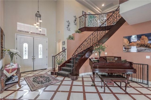 2982 Hammerwood Dr, Las Vegas, NV 89135 - entryway featuring inlaid floor details, baseboards, a high ceiling, stairway, and a chandelier