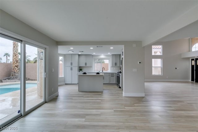 71 Sea Holly Way, Henderson, NV 89074 - kitchen featuring open floor plan, baseboards, a center island, light wood-style flooring, and recessed lighting