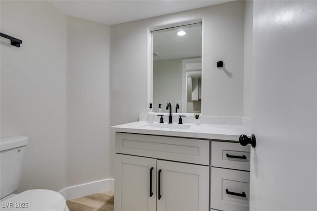 71 Sea Holly Way, Henderson, NV 89074 - bathroom with toilet, vanity, baseboards, wood finished floors, and recessed lighting