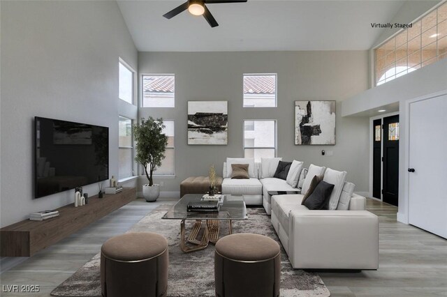 71 Sea Holly Way, Henderson, NV 89074 - living area with high vaulted ceiling, ceiling fan, and wood finished floors