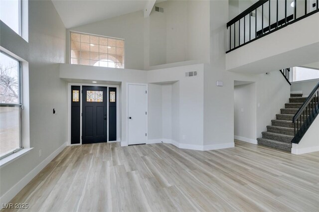 71 Sea Holly Way, Henderson, NV 89074 - entrance foyer with high vaulted ceiling, wood finished floors, stairs, and baseboards