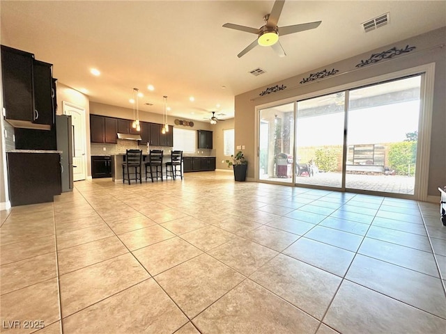 10719 Hammett Park Ave, Las Vegas, NV 89166 - living area with a ceiling fan, light tile patterned floors, and recessed lighting