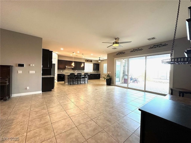 10719 Hammett Park Ave, Las Vegas, NV 89166 - living area featuring ceiling fan, light tile patterned flooring, recessed lighting, and baseboards