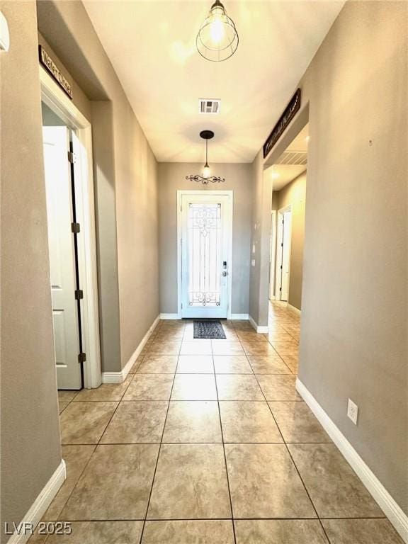 10719 Hammett Park Ave, Las Vegas, NV 89166 - foyer featuring light tile patterned floors and baseboards