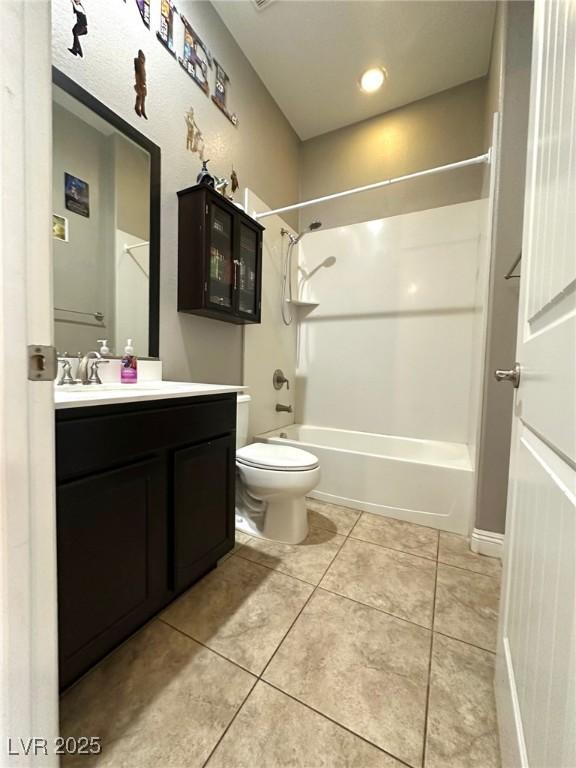 10719 Hammett Park Ave, Las Vegas, NV 89166 - bathroom with shower / bath combination, vanity, toilet, and tile patterned flooring