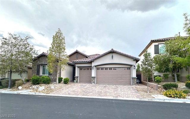 10719 Hammett Park Ave, Las Vegas, NV 89166 - view of front of home with an attached garage, stone siding, stucco siding, decorative driveway, and a tiled roof