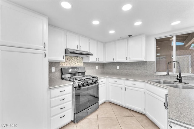 6717 Sheffield Dr, Las Vegas, NV 89108 - kitchen with gas stove, under cabinet range hood, light countertops, white cabinets, and recessed lighting