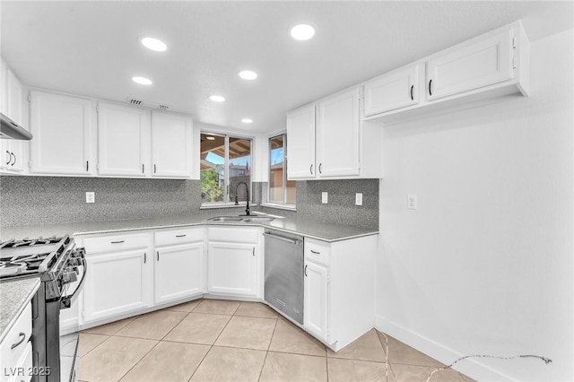 6717 Sheffield Dr, Las Vegas, NV 89108 - kitchen with appliances with stainless steel finishes, decorative backsplash, recessed lighting, white cabinets, and light tile patterned floors
