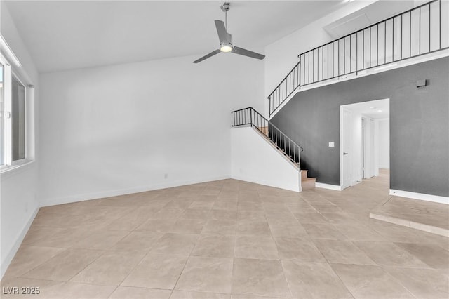6717 Sheffield Dr, Las Vegas, NV 89108 - unfurnished living room with high vaulted ceiling, a ceiling fan, stairs, and light tile patterned flooring