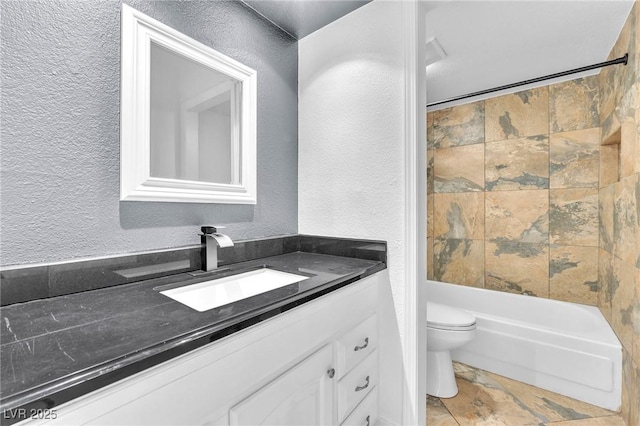 6717 Sheffield Dr, Las Vegas, NV 89108 - bathroom with vanity, a textured wall, stone finish floors, and bathtub / shower combination
