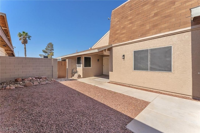 6717 Sheffield Dr, Las Vegas, NV 89108 - rear view of house featuring stucco siding, a patio, and roof with shingles