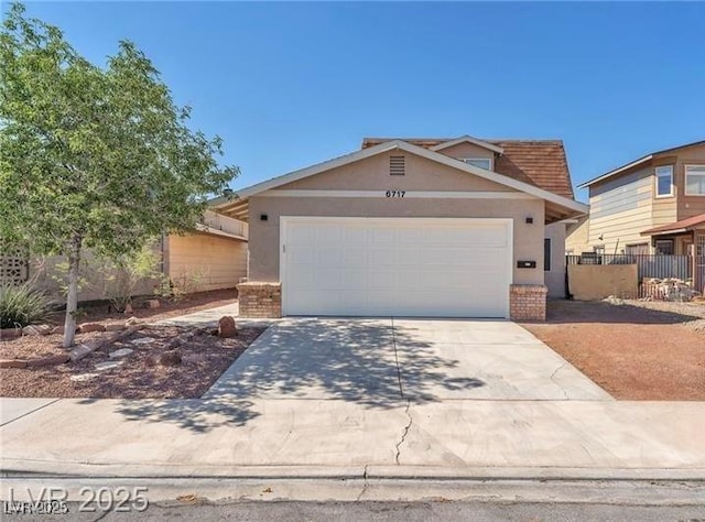 6717 Sheffield Dr, Las Vegas, NV 89108 - view of front facade with brick siding, concrete driveway, stucco siding, and a garage