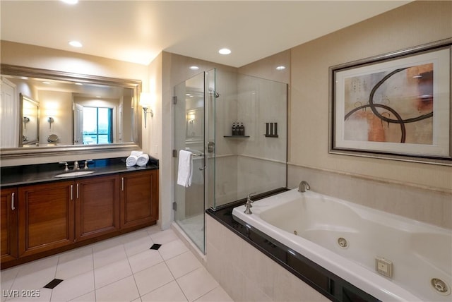 145 E Harmon Ave Unit 1120, Las Vegas, NV 89109 - bathroom featuring a shower stall, a tub with jets, vanity, and tile patterned flooring