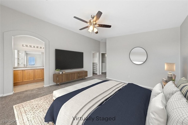 9312 Straw Hays St Unit 103, Las Vegas, NV 89178 - bedroom featuring light colored carpet, ensuite bathroom, and ceiling fan