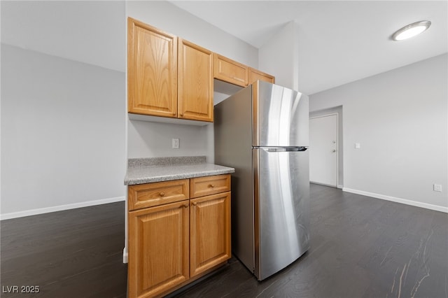 9312 Straw Hays St Unit 103, Las Vegas, NV 89178 - kitchen with freestanding refrigerator, dark wood-style floors, and light countertops