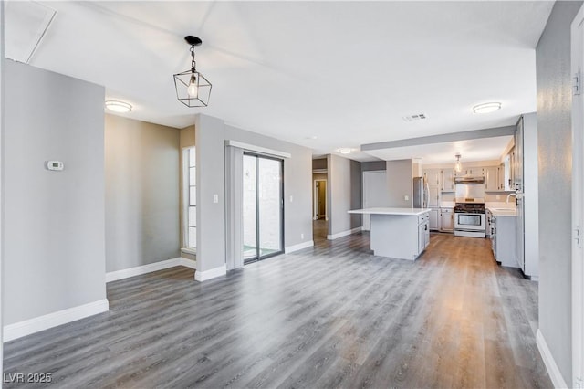3971 Foxboro Cir, Las Vegas, NV 89121 - unfurnished living room with wood finished floors, baseboards, and a sink