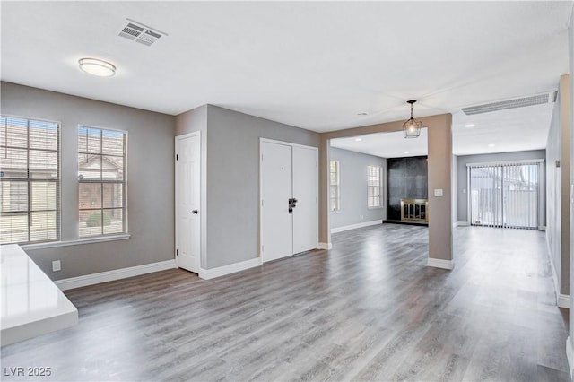 3971 Foxboro Cir, Las Vegas, NV 89121 - unfurnished living room with baseboards, wood finished floors, a fireplace, and recessed lighting