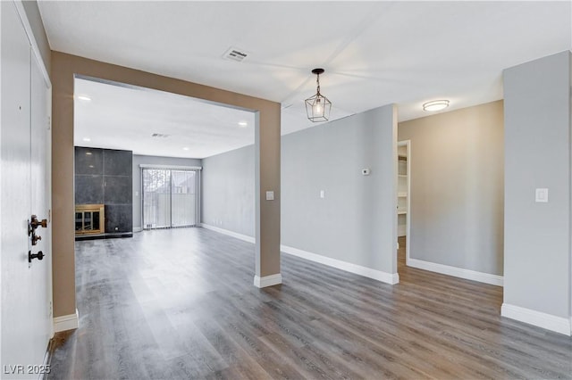 3971 Foxboro Cir, Las Vegas, NV 89121 - unfurnished living room featuring wood finished floors, baseboards, and a tiled fireplace
