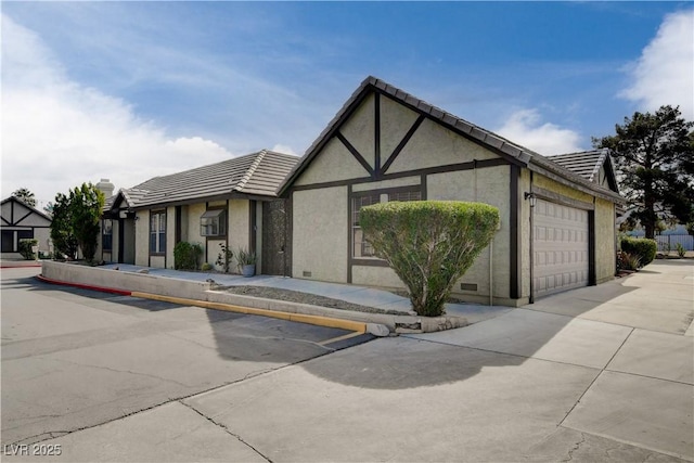 3971 Foxboro Cir, Las Vegas, NV 89121 - english style home with stucco siding, an attached garage, and a tiled roof