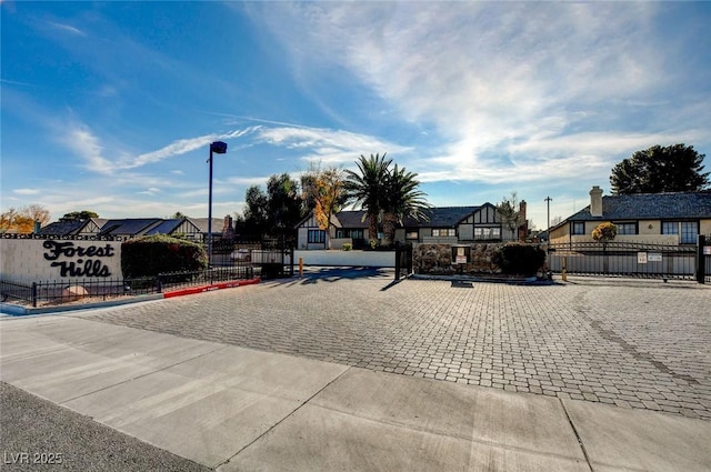 3971 Foxboro Cir, Las Vegas, NV 89121 - view of street with a gated entry, a gate, curbs, a residential view, and street lighting