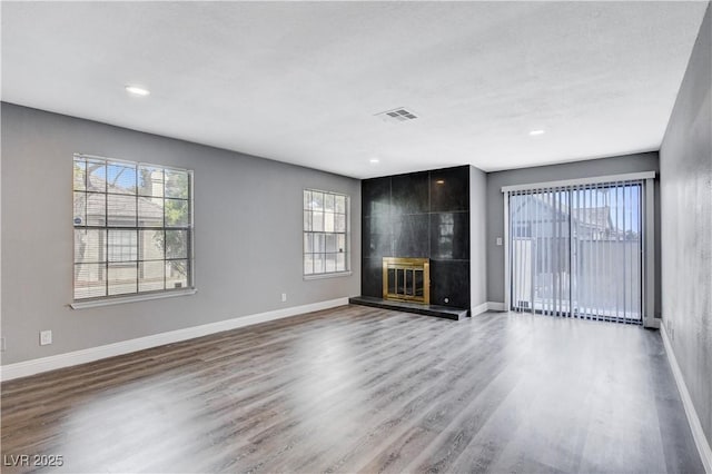 3971 Foxboro Cir, Las Vegas, NV 89121 - unfurnished living room featuring wood finished floors, baseboards, a fireplace, and recessed lighting