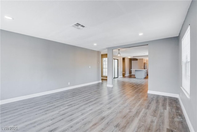 3971 Foxboro Cir, Las Vegas, NV 89121 - unfurnished room featuring light wood-style floors, baseboards, healthy amount of natural light, and recessed lighting