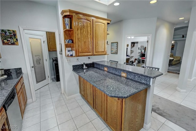 3451 Sagebrush Ave, Pahrump, NV 89048 - kitchen with a peninsula, dishwasher, light tile patterned floors, dark stone counters, and open shelves