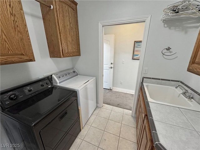 3451 Sagebrush Ave, Pahrump, NV 89048 - laundry room featuring cabinet space, washer and dryer, light tile patterned flooring, and baseboards