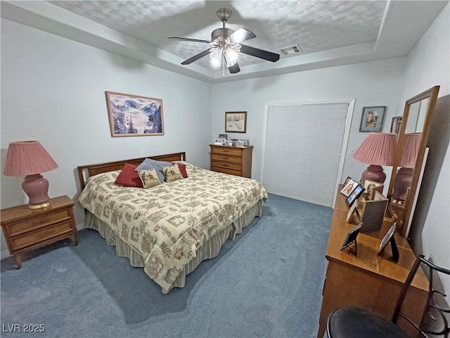 3451 Sagebrush Ave, Pahrump, NV 89048 - bedroom featuring carpet, a tray ceiling, a textured ceiling, and ceiling fan