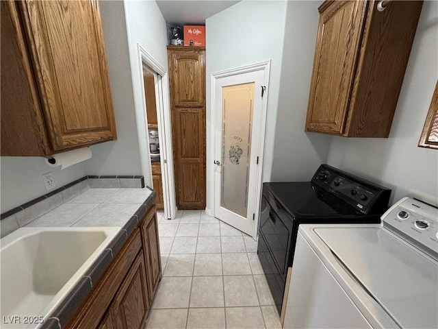 3451 Sagebrush Ave, Pahrump, NV 89048 - laundry room featuring cabinet space, washing machine and dryer, and light tile patterned flooring