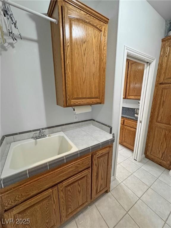 3451 Sagebrush Ave, Pahrump, NV 89048 - laundry area with a sink and light tile patterned flooring
