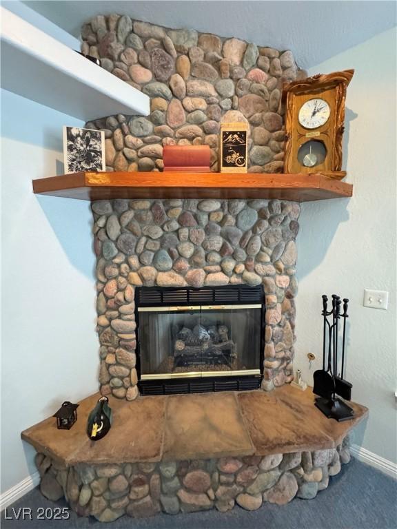 3451 Sagebrush Ave, Pahrump, NV 89048 - detailed view of baseboards, carpet floors, and a stone fireplace