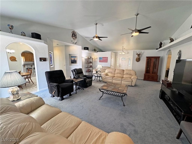 3451 Sagebrush Ave, Pahrump, NV 89048 - living area featuring arched walkways, vaulted ceiling, light colored carpet, and a ceiling fan