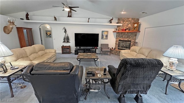 3451 Sagebrush Ave, Pahrump, NV 89048 - living room with carpet flooring, ceiling fan, vaulted ceiling, and a stone fireplace