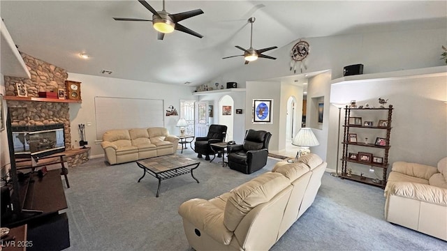 3451 Sagebrush Ave, Pahrump, NV 89048 - living room featuring lofted ceiling, a ceiling fan, carpet, a fireplace, and arched walkways