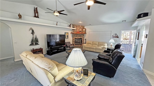3451 Sagebrush Ave, Pahrump, NV 89048 - living area featuring arched walkways, carpet flooring, ceiling fan, a stone fireplace, and lofted ceiling