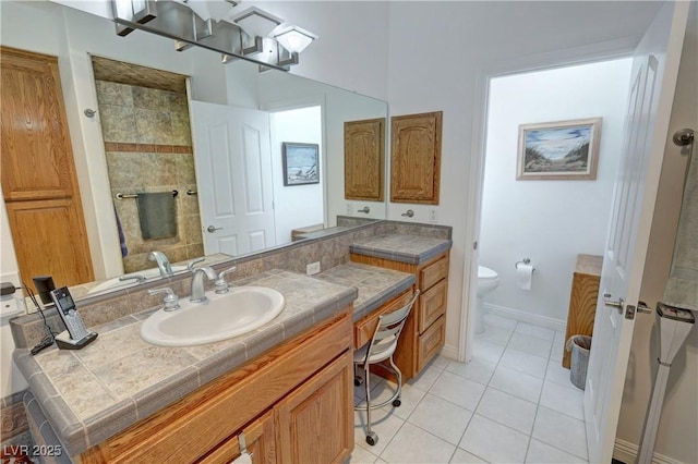 3451 Sagebrush Ave, Pahrump, NV 89048 - full bathroom with vanity, toilet, tile patterned floors, baseboards, and tiled shower