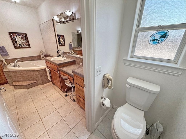 3451 Sagebrush Ave, Pahrump, NV 89048 - bathroom featuring tile patterned floors, vanity, a bath, and toilet