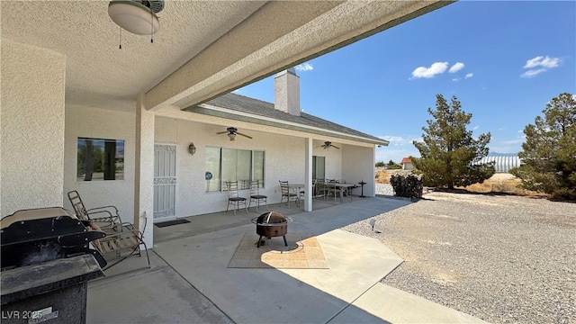 3451 Sagebrush Ave, Pahrump, NV 89048 - view of patio / terrace featuring an outdoor fire pit, a ceiling fan, and outdoor dining space