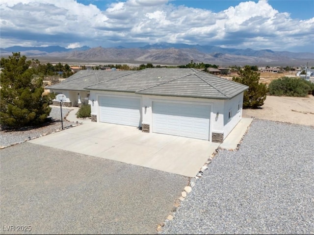 3451 Sagebrush Ave, Pahrump, NV 89048 - garage with concrete driveway and a mountain view